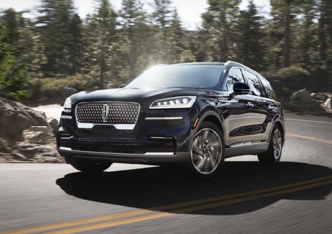 A Lincoln Aviator® SUV is being driven on a winding mountain road | LaFontaine Lincoln Grand Rapids in Grand Rapids MI