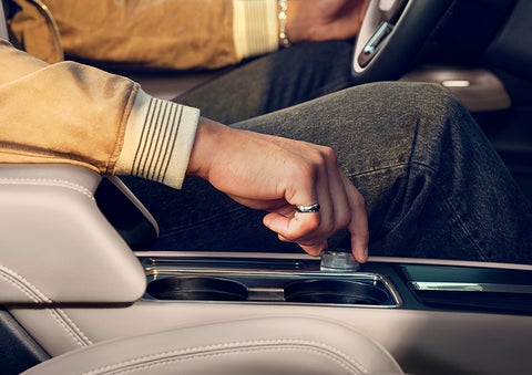 The driver of a 2024 Lincoln Corsair® SUV is shown selecting the drive mode. | LaFontaine Lincoln Grand Rapids in Grand Rapids MI