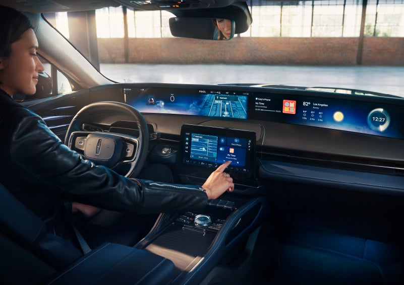 The driver of a 2024 Lincoln Nautilus® SUV interacts with the center touchscreen. | LaFontaine Lincoln Grand Rapids in Grand Rapids MI