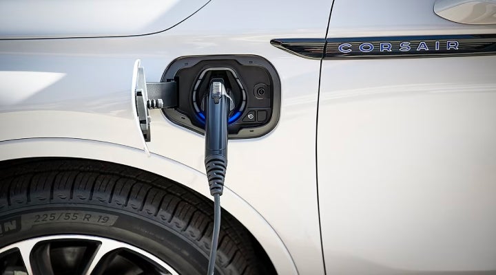 An electric charger is shown plugged into the charging port of a Lincoln Corsair® Grand Touring
model. | LaFontaine Lincoln Grand Rapids in Grand Rapids MI