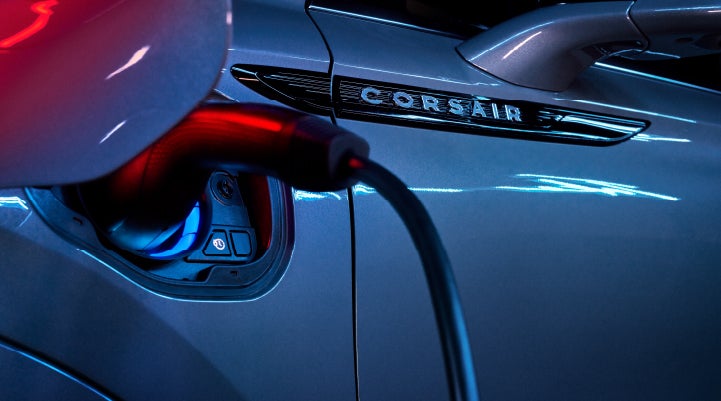 A charger plugged into the charging port of a 2024 Lincoln Corsair® Plug-in Hybrid model. | LaFontaine Lincoln Grand Rapids in Grand Rapids MI