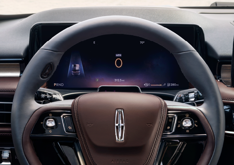 The steering wheel of 2025 Lincoln Aviator® SUV is shown with black and brown accents. | LaFontaine Lincoln Grand Rapids in Grand Rapids MI