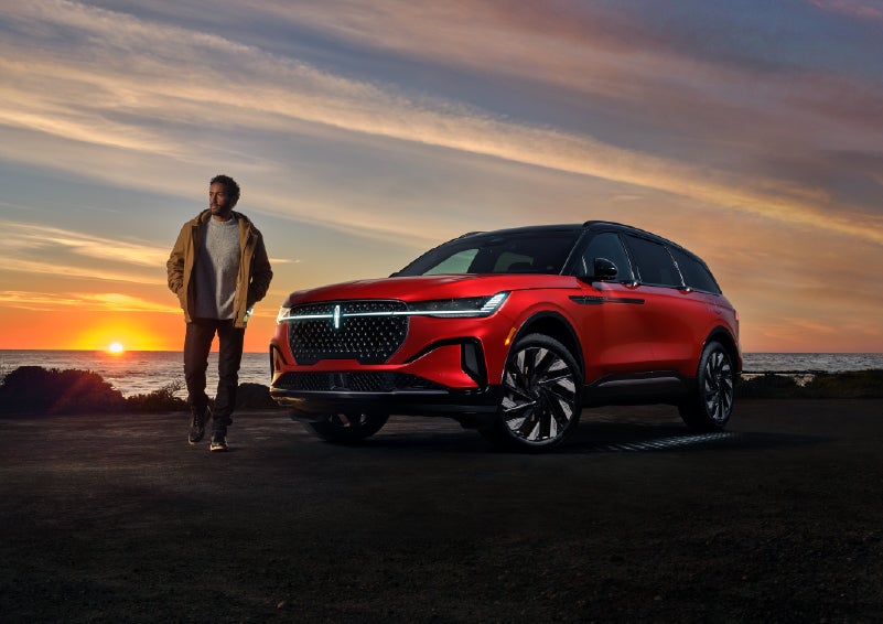 A person is shown next to a 2025 Lincoln Nautilus® SUV as the Lincoln Embrace sequence takes place. | LaFontaine Lincoln Grand Rapids in Grand Rapids MI
