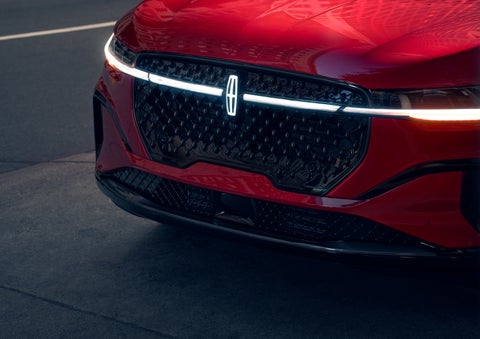 The available front LED light bar and center Lincoln Star logo glow at dusk. | LaFontaine Lincoln Grand Rapids in Grand Rapids MI