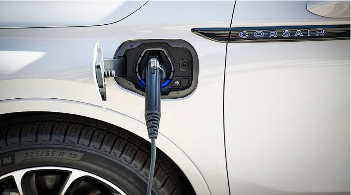 An electric charger is shown plugged into the charging port of a Lincoln Corsair® Grand Touring
model. | LaFontaine Lincoln Grand Rapids in Grand Rapids MI