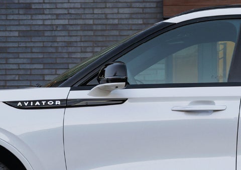 The driver’s side door and fender badging of a white 2026 Lincoln Aviator® SUV are showcased. | LaFontaine Lincoln Grand Rapids in Grand Rapids MI