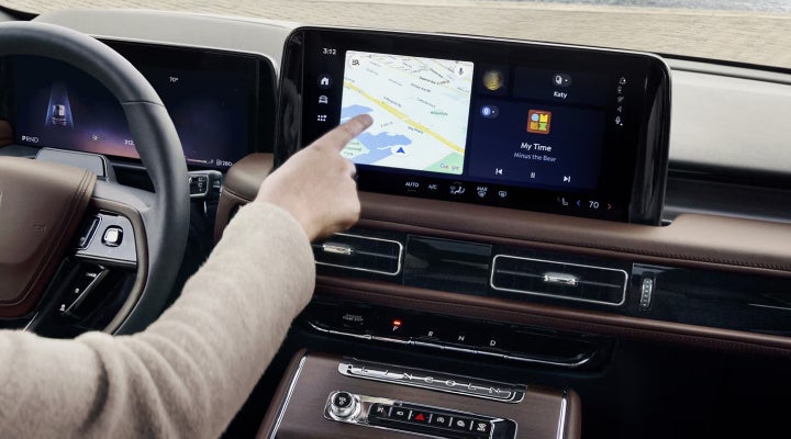 A person is tapping the center display touchscreen of a 2026 Lincoln Aviator® SUV. | LaFontaine Lincoln Grand Rapids in Grand Rapids MI