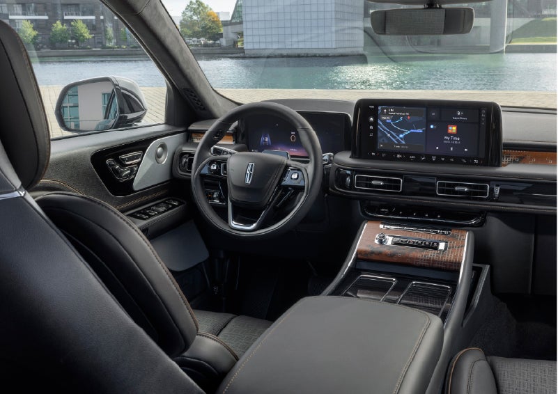 The interior of the 2026 Lincoln Aviator® SUV is shown parked with a view of a harbor through the windshield. | LaFontaine Lincoln Grand Rapids in Grand Rapids MI