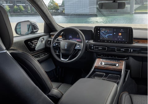 The interior of the 2026 Lincoln Aviator® SUV is shown parked with a view of a harbor through the windshield. | LaFontaine Lincoln Grand Rapids in Grand Rapids MI