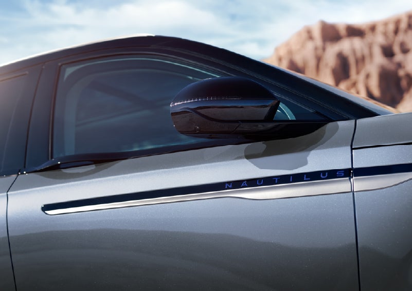 Blue lettering on the side of the vehicle that reads Nautilus indicates the available Hybrid Powertrain. | LaFontaine Lincoln Grand Rapids in Grand Rapids MI