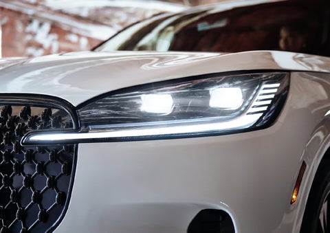A close-up of a headlamp on the 2027 Lincoln Aviator® SUV is shown. | LaFontaine Lincoln Grand Rapids in Grand Rapids MI