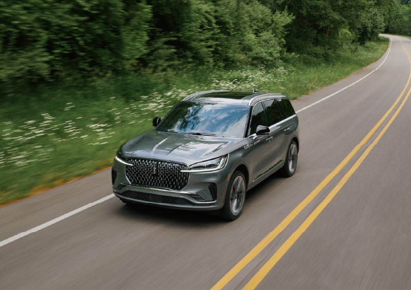 A 2027 Lincoln Aviator® SUV is being driven down a road. | LaFontaine Lincoln Grand Rapids in Grand Rapids MI