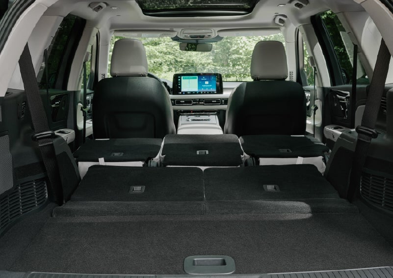 A rear to front view of the interior of a 2027 Lincoln Aviator® Black Label™ SUV shows the third and second rows folded flat | LaFontaine Lincoln Grand Rapids in Grand Rapids MI