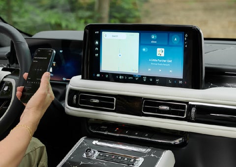 A person pairs thier phone with the center touchscreen of a 2027 Lincoln Aviator® Black Label™ SUV | LaFontaine Lincoln Grand Rapids in Grand Rapids MI