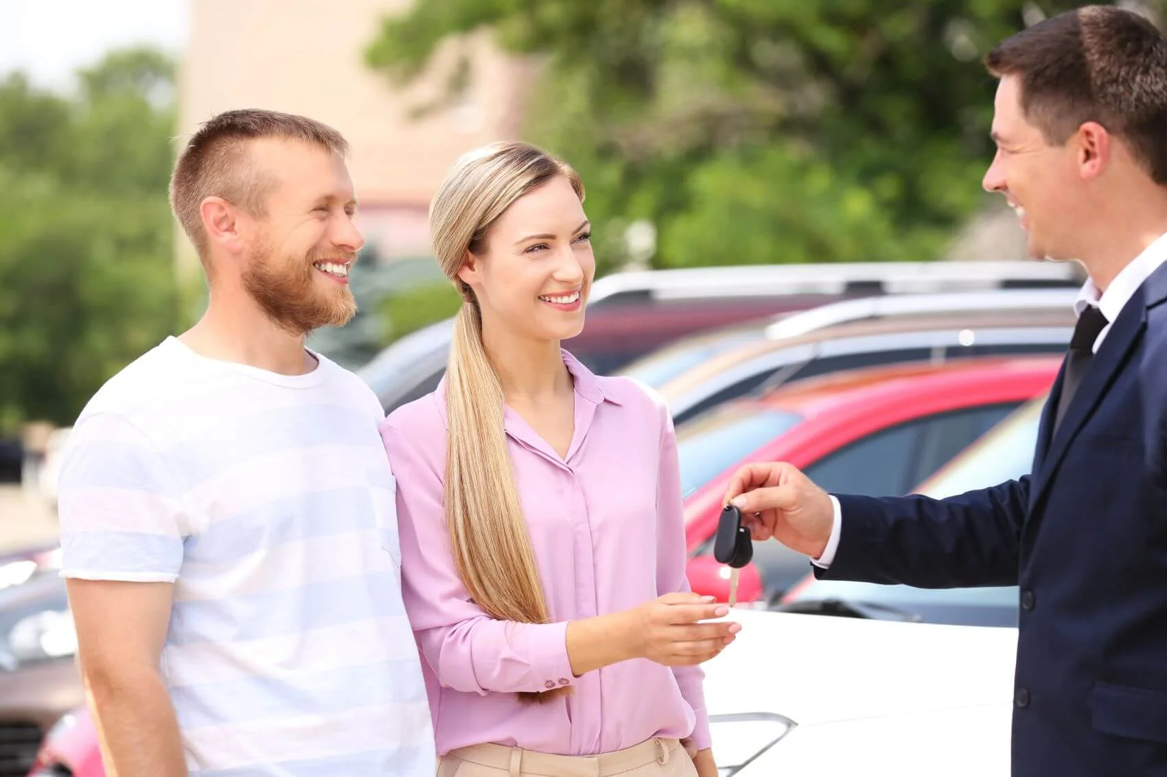 Couple Taking Keys from Dealer