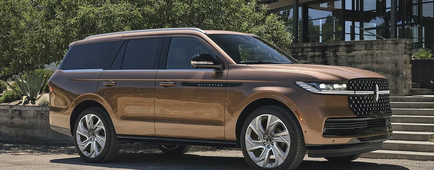 Brown 2026 Lincoln Navigator driving through an intersection.