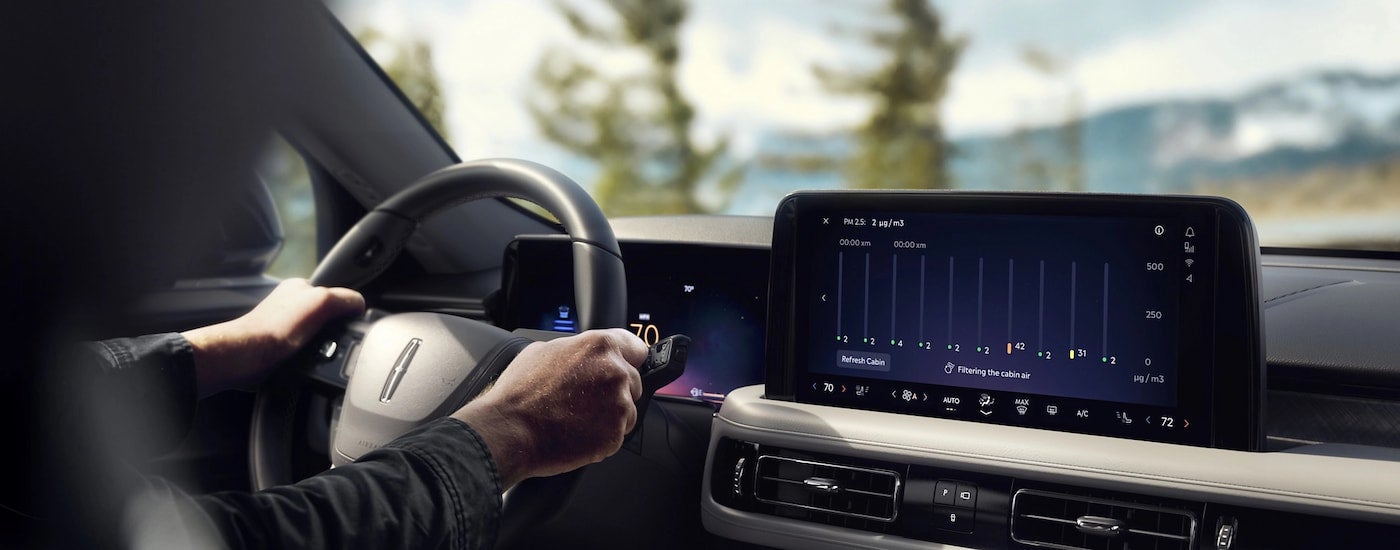 Person sitting in the driver seat of a 2026 Lincoln Aviator.