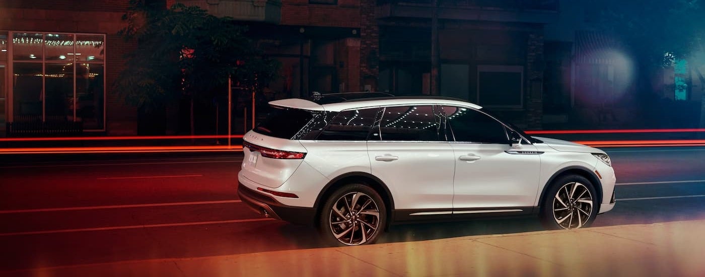 Rear of a white 2026 Lincoln Corsair parked by a curb.