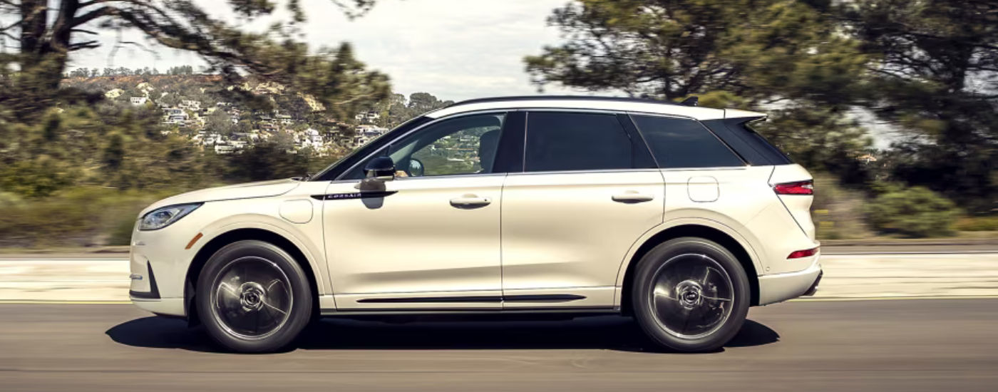 White 2026 Lincoln Corsair driving down an open road
