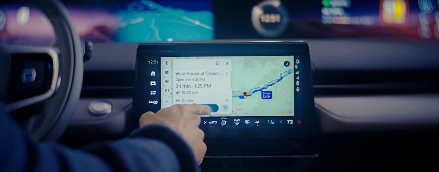 Person using the map infotainment screen in a 2026 Lincoln Nautilus