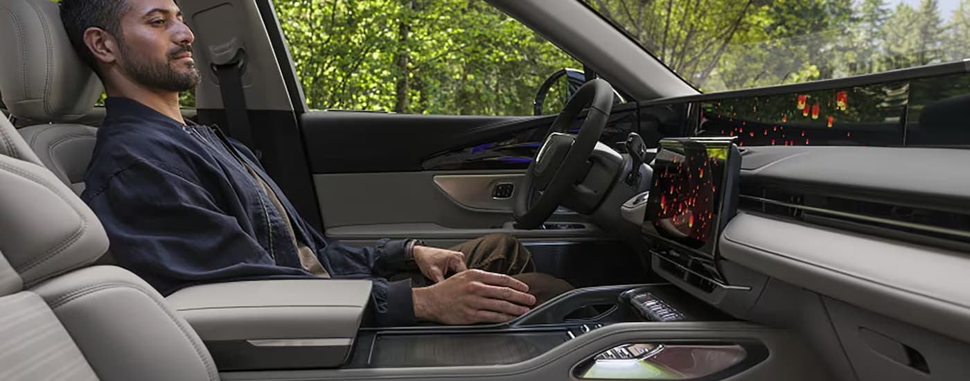Man sitting in the driver's seat of a 2026 Lincoln Nautilus