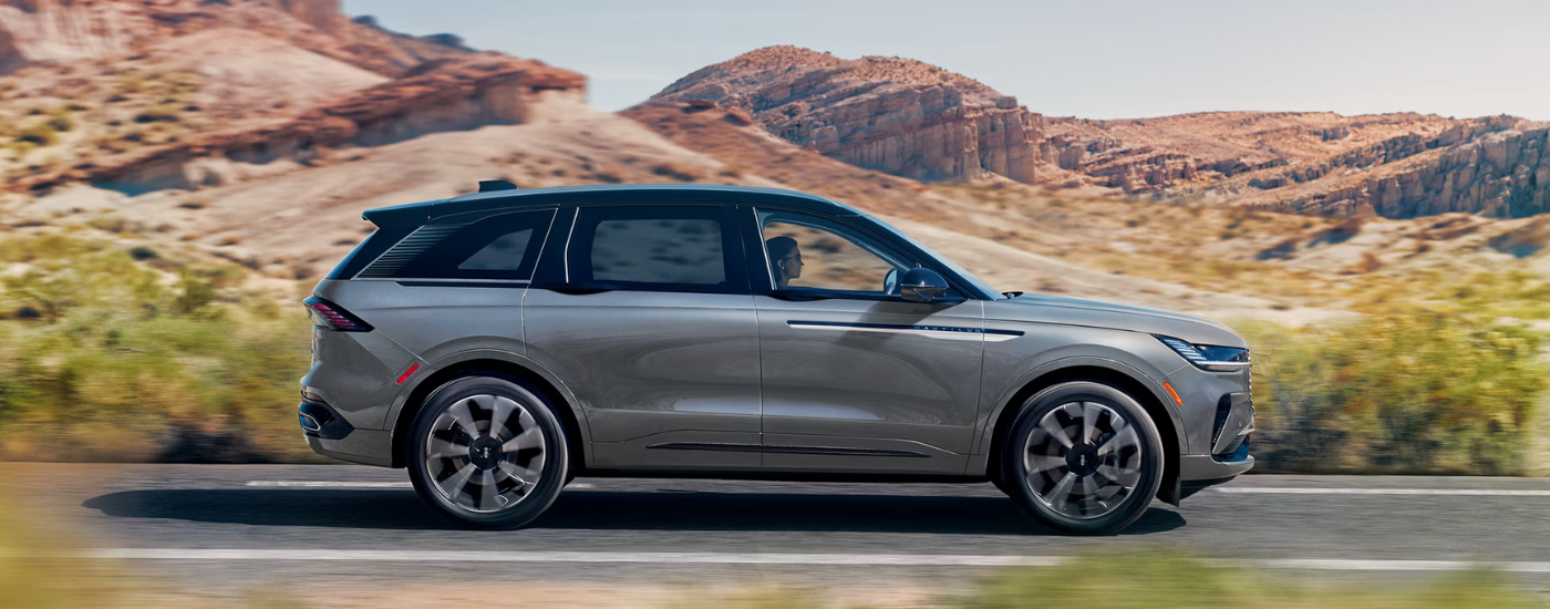 Grey 2026 Lincoln Nautilus driving past some canyons