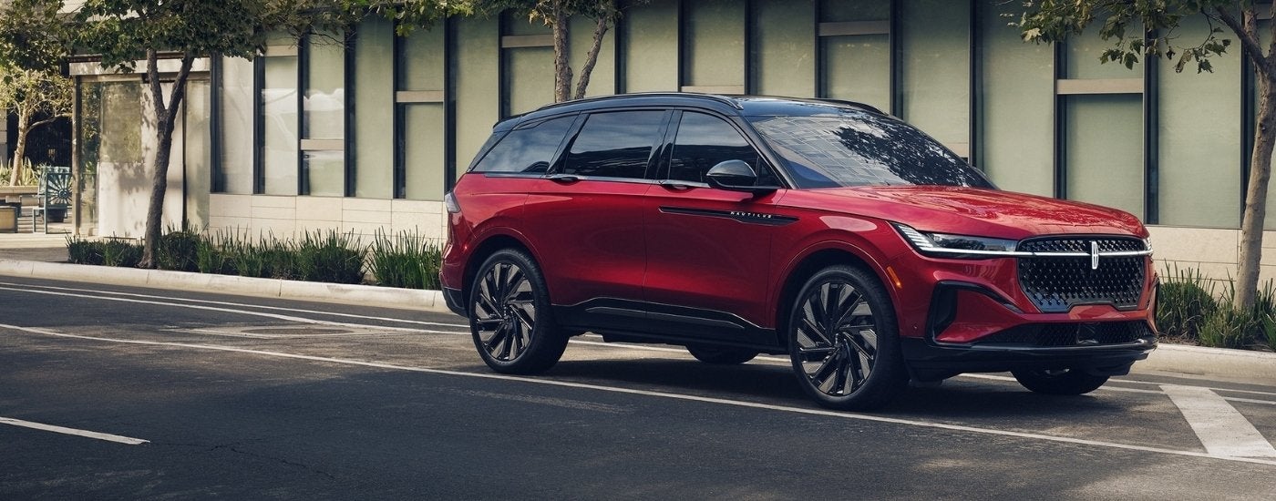 A red 2024 Lincoln Nautilus parked in a city street.