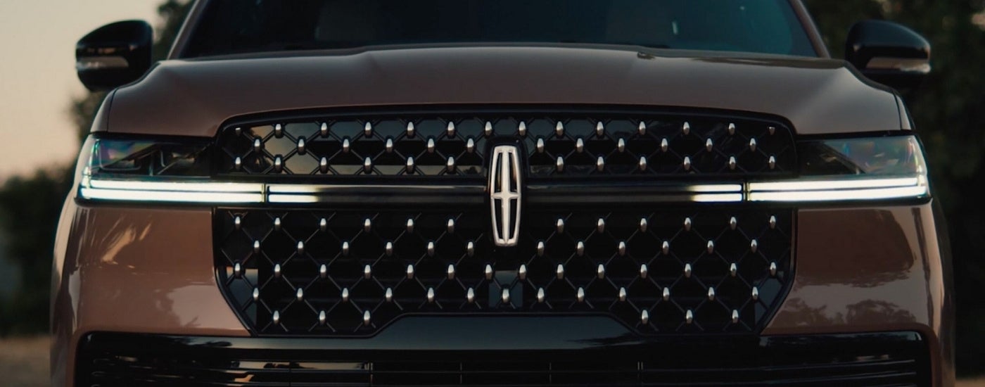 Grille and headlights on a brown 2025 Lincoln Navigator.