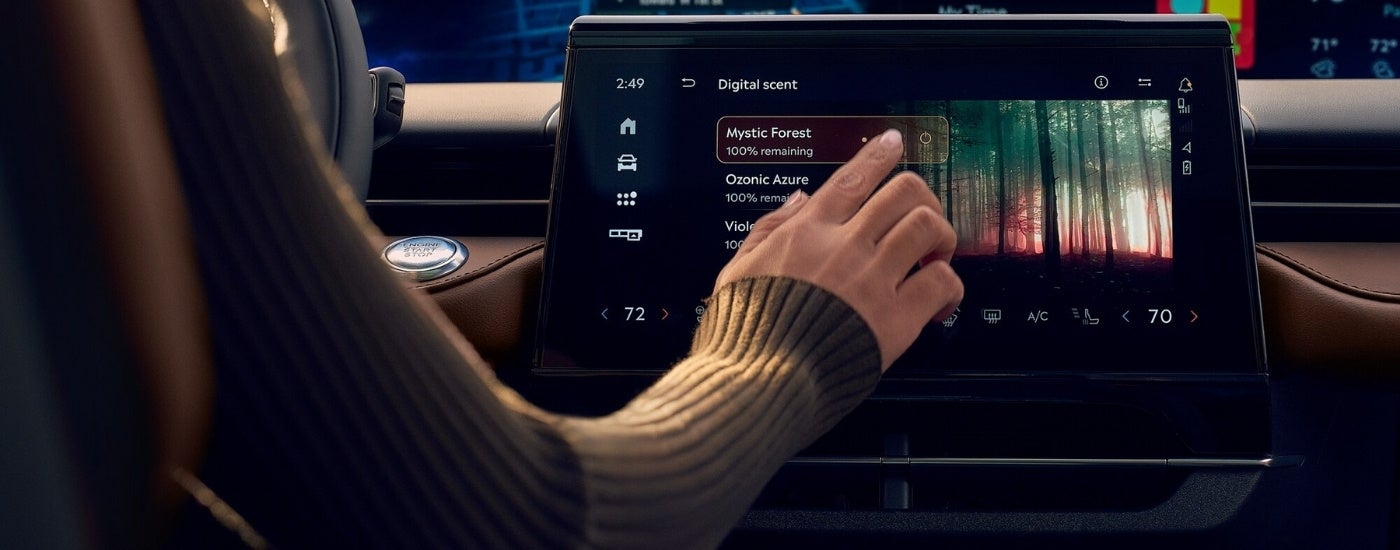 Person using the infotainment screen in a 2026 Lincoln Nautilus 