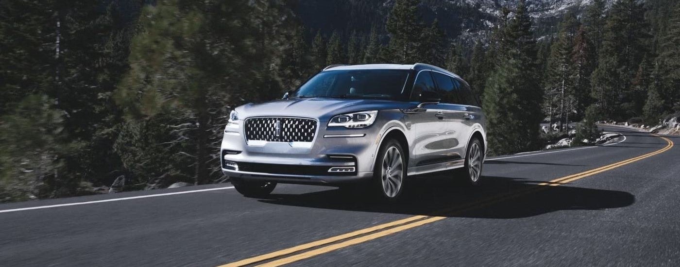 A silver 2023 Lincoln Aviator driving on a highway.