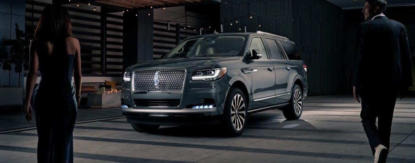 A gray 2023 Lincoln Navigator parked in a used car dealership.