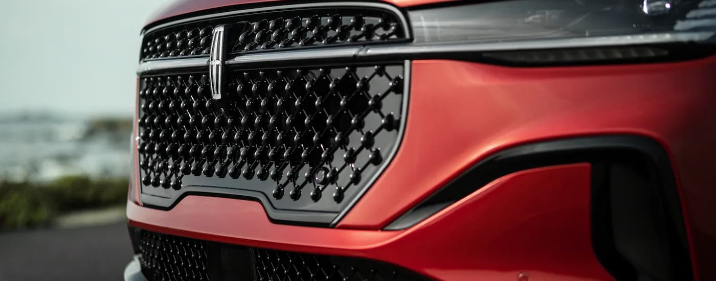 Close up of the grille on a used red 2024 Lincoln Nautilus for sale